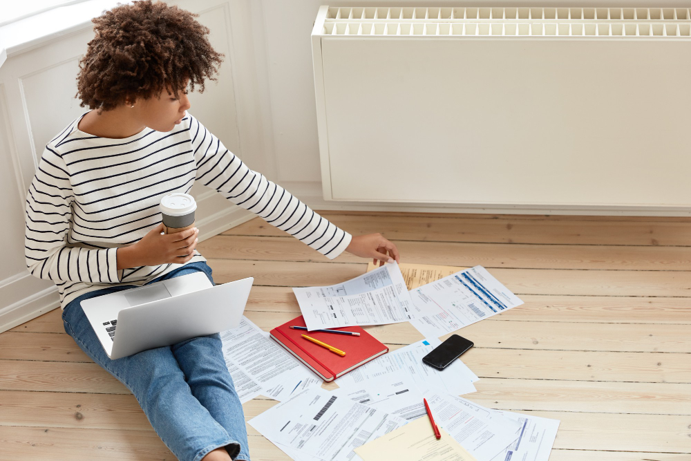 Australian family sitting together reviewing household bills and savings charts